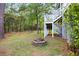 Backyard featuring a brick firepit and stairs leading to an elevated deck, ideal for relaxing and enjoying the outdoors at 521 Sanders Farm Ln, Wando, SC 29492