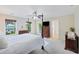 Bright main bedroom featuring a four-poster bed, neutral carpet, and natural light from windows at 521 Sanders Farm Ln, Wando, SC 29492