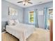 Bedroom with blue walls, white bedding, and bright natural light at 521 Sanders Farm Ln, Wando, SC 29492