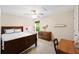 Comfortable bedroom with dark wood furnishings and soft natural light at 521 Sanders Farm Ln, Wando, SC 29492