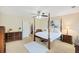 Spacious bedroom with four-poster bed, ceiling fan, and soft natural light at 521 Sanders Farm Ln, Wando, SC 29492