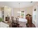 Classic dining room with dark wood floors, white walls, a chandelier, and furniture with lots of wood detail at 521 Sanders Farm Ln, Wando, SC 29492
