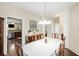 Inviting dining room featuring a pendant light fixture, dark wood floors, and convenient access to the kitchen at 521 Sanders Farm Ln, Wando, SC 29492