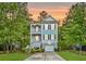 Charming two-story home with a double porch, beautiful trees, nice landscaping, and driveway leading to a garage at 521 Sanders Farm Ln, Wando, SC 29492