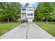 Charming two-story home with a long driveway, classic white trim, a two-car garage and a welcoming facade at 521 Sanders Farm Ln, Wando, SC 29492