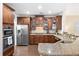Well-equipped kitchen with stainless steel appliances, granite countertops, dark wood cabinetry, and dark wood floors at 521 Sanders Farm Ln, Wando, SC 29492