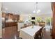 An open floor plan showcases a kitchen, dining room, and living room areas with seamless transitions and cohesive design at 521 Sanders Farm Ln, Wando, SC 29492
