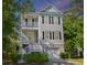 Charming two-story home with a beautiful front porch and a well-maintained lawn at 521 Sanders Farm Ln, Wando, SC 29492