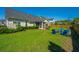Lush backyard with manicured lawn, patio, and firepit area, perfect for relaxing and entertaining guests at 521 Yellow Tower Ter, Charleston, SC 29412