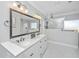 Bright bathroom featuring a double sink vanity, a marble tiled shower with glass partition, and modern fixtures at 521 Yellow Tower Ter, Charleston, SC 29412