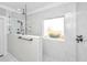 Tiled shower with rainfall showerhead and glass partition next to window at 521 Yellow Tower Ter, Charleston, SC 29412