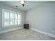 A neutral bedroom with light carpet, a ceiling fan, plus window with white shutters at 521 Yellow Tower Ter, Charleston, SC 29412