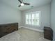 A neutral bedroom with light carpet, a ceiling fan, plus window with white shutters at 521 Yellow Tower Ter, Charleston, SC 29412