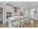 Modern kitchen with a large island, stainless steel appliances, white cabinets, and stylish pendant lighting at 521 Yellow Tower Ter, Charleston, SC 29412