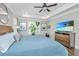 Serene main bedroom featuring tray ceilings, plantation shutters, and a ceiling fan with ample natural light at 521 Yellow Tower Ter, Charleston, SC 29412