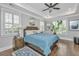 Bright main bedroom with a tray ceiling, ceiling fan, plantation shutters, and hardwood floors at 521 Yellow Tower Ter, Charleston, SC 29412