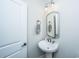 Elegant powder room featuring a pedestal sink, ornate mirror, and a well-lit, clean aesthetic at 521 Yellow Tower Ter, Charleston, SC 29412