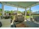 View of a screened in porch with view of yard and neighborhood, along with a barbecue grill and exterior pizza oven at 521 Yellow Tower Ter, Charleston, SC 29412