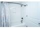 Spotless white tiled shower with modern bronze fixtures, and a coordinating patterned curtain at 521 Yellow Tower Ter, Charleston, SC 29412