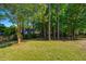 Backyard with mature trees, lawn, and fenced perimeter at 522 Antebellum Ln, Mount Pleasant, SC 29464