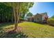 Green backyard featuring trees, well-maintained lawn, and patio with exterior of house at 522 Antebellum Ln, Mount Pleasant, SC 29464