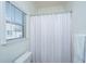 Bathroom with white shower curtain, toilet, and window for natural light at 522 Antebellum Ln, Mount Pleasant, SC 29464
