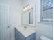 Bright bathroom with a blue vanity and natural light from the window at 522 Antebellum Ln, Mount Pleasant, SC 29464