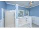 Bright blue bathroom with a combination shower and tub, tiled floors, and window for natural light at 522 Antebellum Ln, Mount Pleasant, SC 29464