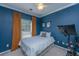 Modern bedroom featuring blue walls, a ceiling fan, window with curtains, and a Peloton bike at 522 Antebellum Ln, Mount Pleasant, SC 29464