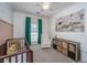 Cozy bedroom features a brown crib, white chair, and soft, neutral décor at 522 Antebellum Ln, Mount Pleasant, SC 29464