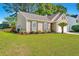 Charming single-story home with manicured lawn, fresh mulch, well maintained landscaping, and a two car garage at 522 Antebellum Ln, Mount Pleasant, SC 29464