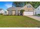 Attractive single-Gathering home featuring a well-manicured front lawn and attached garage at 522 Antebellum Ln, Mount Pleasant, SC 29464