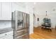 Stainless steel refrigerator in a bright kitchen with white cabinets and view into dining area at 522 Antebellum Ln, Mount Pleasant, SC 29464