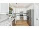 Modern kitchen featuring stainless steel appliances, granite countertops, and white cabinets at 522 Antebellum Ln, Mount Pleasant, SC 29464