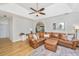 Bright living room features a leather sectional, ceiling fan, and vaulted ceiling at 522 Antebellum Ln, Mount Pleasant, SC 29464