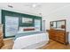 Bedroom with a paneled green wall, light colored wood floors, and a ceiling fan at 522 Antebellum Ln, Mount Pleasant, SC 29464