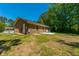 A spacious backyard shows a brick house with a concrete patio, lawn, and mature trees at 523 Bayshore Blvd, Goose Creek, SC 29445