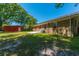 A brick house has a large backyard with a red shed, patio, and green trees at 523 Bayshore Blvd, Goose Creek, SC 29445