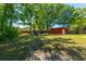 Landscaped backyard featuring a fire pit with chairs and storage sheds at 523 Bayshore Blvd, Goose Creek, SC 29445