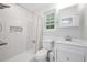 Modern bathroom with stylish tiled shower, white vanity, updated fixtures, and window at 523 Bayshore Blvd, Goose Creek, SC 29445