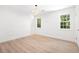Clean bedroom showcasing two windows, light-colored wood-look floors, and neutral paint at 523 Bayshore Blvd, Goose Creek, SC 29445