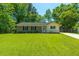 Charming one-story home with a well-manicured lawn, brick accents, and beautiful landscaping at 523 Bayshore Blvd, Goose Creek, SC 29445