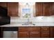 Well-appointed kitchen with stainless steel dishwasher and dark wood cabinetry and granite countertops at 523 Bayshore Blvd, Goose Creek, SC 29445