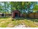 Outdoor storage shed with roll up door on green lawn under shady trees at 523 Bayshore Blvd, Goose Creek, SC 29445