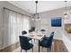 Well-lit dining room featuring modern pendant lighting, a dining table with chairs, and a view to the backyard at 525 Purple Finch Rd, Summerville, SC 29486