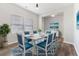Airy dining room features a dining table and blue chairs set on a patterned rug, and a large window at 525 Purple Finch Rd, Summerville, SC 29486