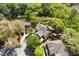 Expansive aerial view of a home nestled among lush trees and foliage, backing onto a serene pond at 5471 Rising Tide, North Charleston, SC 29420