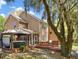Backyard with large wooden deck, gazebo-covered hot tub, and wooded view at 5471 Rising Tide, North Charleston, SC 29420