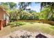Wide backyard with a wooden fence and mature trees at 5471 Rising Tide, North Charleston, SC 29420
