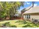 Large grassy backyard with wooden fence, mature trees, and a hot tub under a gazebo at 5471 Rising Tide, North Charleston, SC 29420
